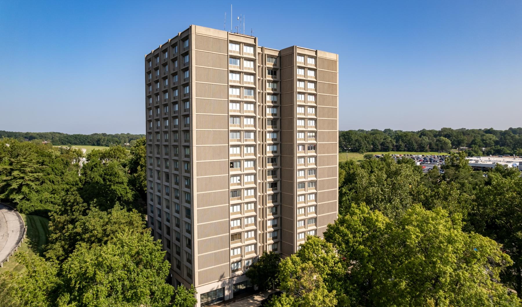 a tall building surrounded by trees