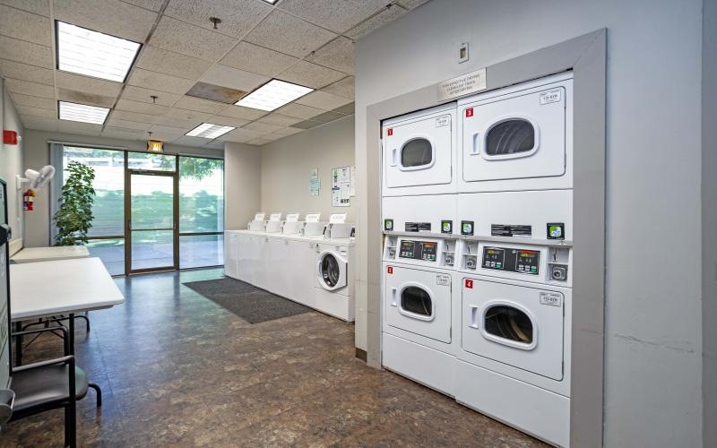 a room with washing machines and a table